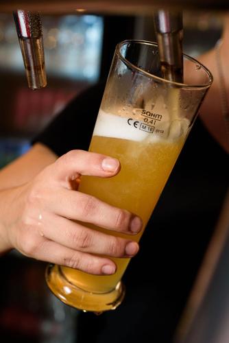 a person is holding a glass of beer at Villaggio Orizzonte in Riotorto