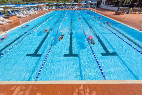 a group of people swimming in a swimming pool at Villaggio Orizzonte in Riotorto