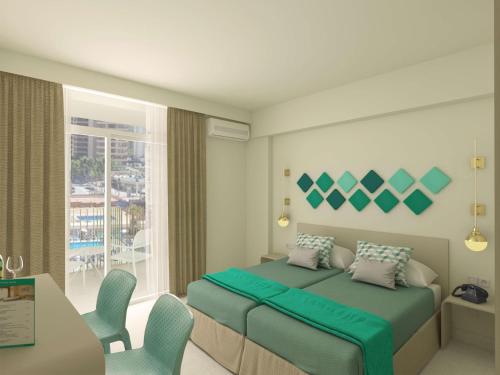 a bedroom with a bed and a table and chairs at Hotel Gala Placidia 3'''sup in Benidorm