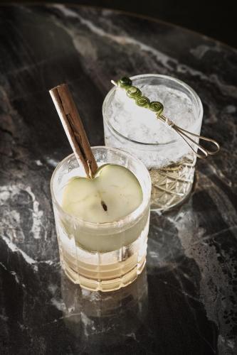a candle with a spoon in a glass on a table at Meliá London Kensington Member of Meliá Collection in London