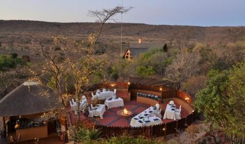 an aerial view of a house with a table and chairs at Kololo Game Reserve in Welgevonden Game Reserve