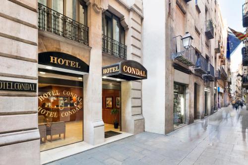 a city street with a hotel goodwill sign on a building at Hotel Condal in Barcelona