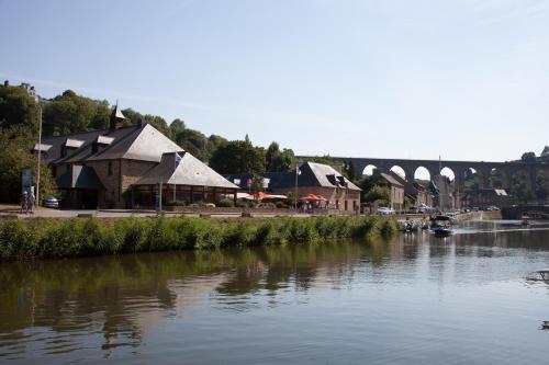 a view of a river with a bridge in the background at Mercure Dinan Port Le Jerzual in Dinan