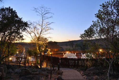 a view of a patio at night with lights at Kololo Game Reserve in Welgevonden Game Reserve