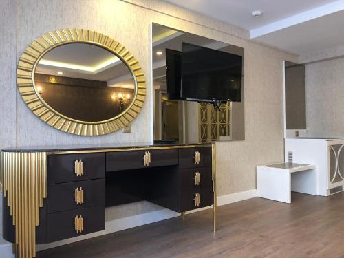 a living room with a large mirror and a dresser at Burj Al Istanbul in Istanbul