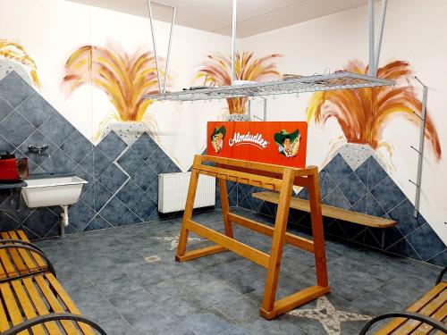 a bathroom with a sink and a wooden bench at Hotel Gailberghöhe in Kötschach