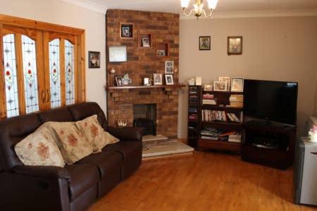 a living room with a couch and a fireplace at killowen in Dublin