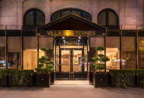 a large building with a sign on the front of it at La Villa des Ternes in Paris