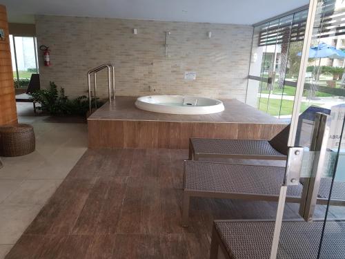 a bathroom with a bath tub in a building at Beach Place Aquiraz Riviera in Aquiraz