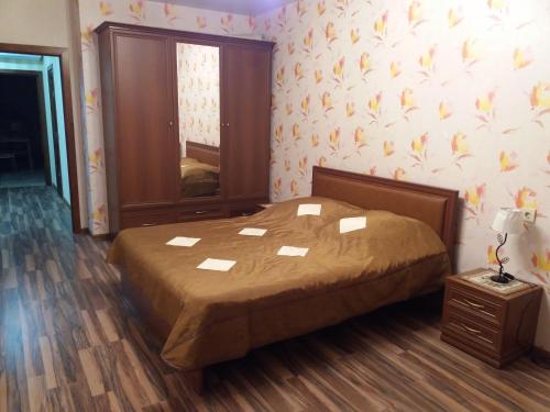 a bedroom with a bed and a wall with flowers at Новая двухкомнатная квартира в центре Воронежа. in Voronezh