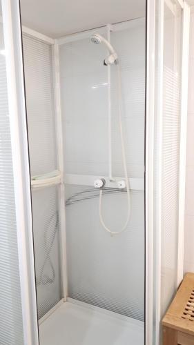 a shower with a glass door in a bathroom at Arctic Rooms HAGE in Tromsø