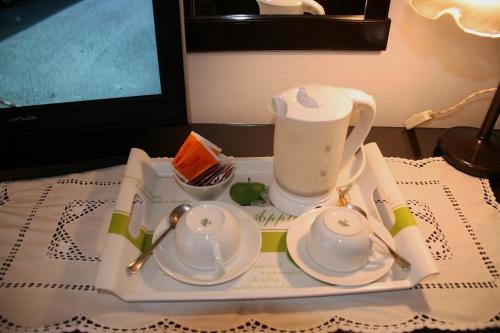 a tray with a tea set on top of a table at Meublé il Riccio in Montepulciano