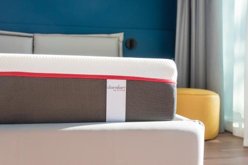 a close up of a bed in a bedroom at HOODY ACTIVE & HAPPINESS HOTEL in Arco