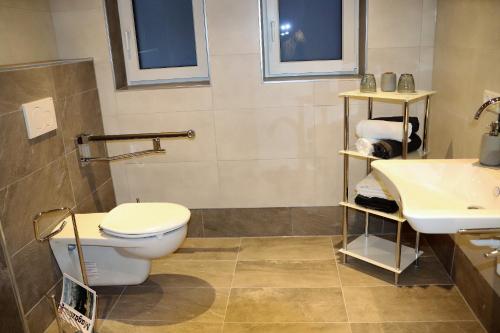 a bathroom with a toilet and a sink at Haus Neuwirt in Sautens