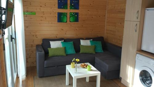 a living room with a couch and a table at Apartadiño in Pobra do Caramiñal