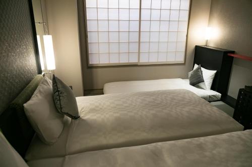 Una cama o camas en una habitación de Hotel Resol Trinity Kyoto