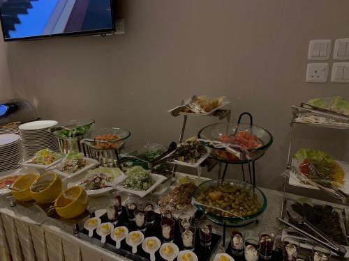 a buffet with many dishes of food on a table at Swiss In Park Tabuk in Tabuk