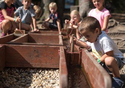 a group of children playing with a toy train at Stodola na Bílé in Bílá