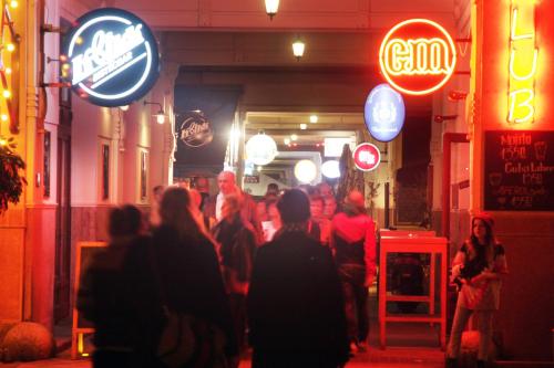 a group of people walking down a street at night at Gozsdu Court Budapest in Budapest