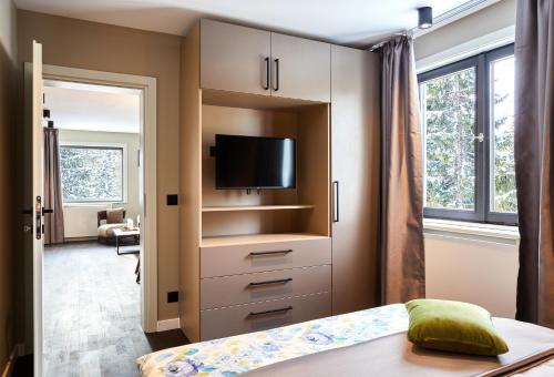 a bedroom with a bed and a tv on a cabinet at das Valdo in Seefeld in Tirol