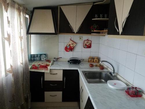 a kitchen with a sink and a counter top at INN Korça, Center City Apartament in Korçë