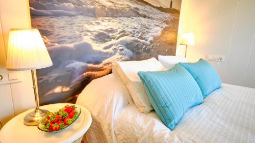 a bedroom with a bed with a painting on the wall at Casa Reyes El Palmar in El Palmar