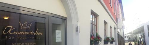 a building with a sign on the window of a store at Boutique-Hotel Kronenstuben in Ludwigsburg