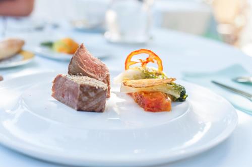a white plate with three different types of food on it at Hôtel Beau Rivage Condrieu in Condrieu