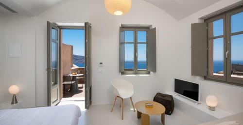 a bedroom with a bed and a view of the ocean at Old Castle Oia in Oia