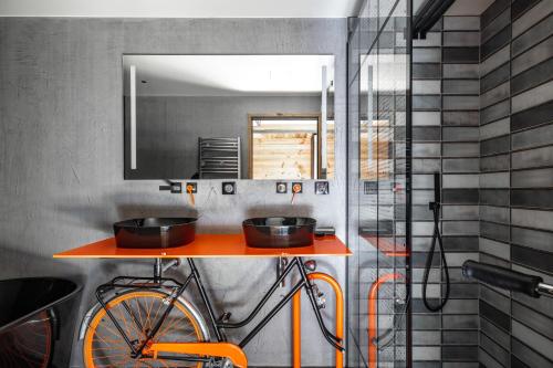 a kitchen with a bike on a shelf with two pans at Chalet Carte Blanche Banksy in Tignes