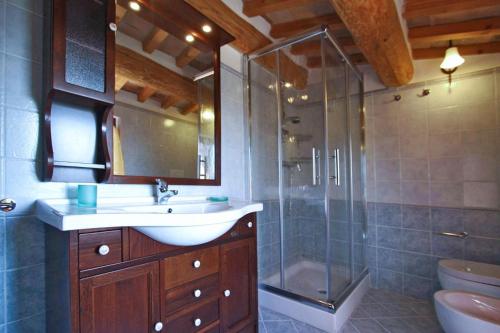 a bathroom with a sink and a glass shower at Appartamento Corallo in Cagli