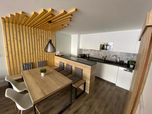 a kitchen and dining room with a wooden table and chairs at Apartment Andrea in Maria Alm am Steinernen Meer