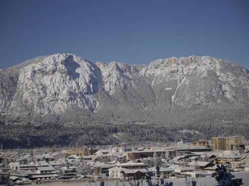 a mountain in the background of a city with a town at Be 550 in Wörgl