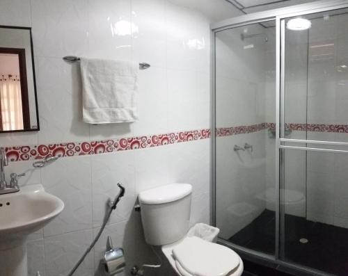 a bathroom with a shower and a toilet and a sink at Finca Hotel Andaquies in Armenia