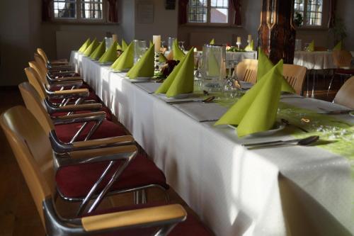 a row of tables with green napkins on them at Schlosshotel am Hainich in Behringen