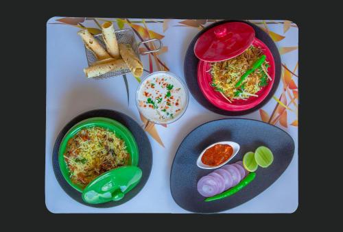 a table with plates of food and bowls of food at Caravela Beach Resort in Varca