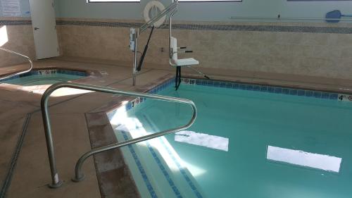 a large swimming pool with a hand rail in it at Holiday Inn Express & Suites Springville-South Provo Area by IHG in Springville