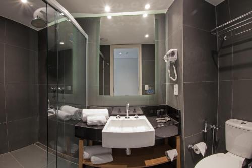 a bathroom with a sink and a shower and a toilet at ibis Styles Palmas in Palmas