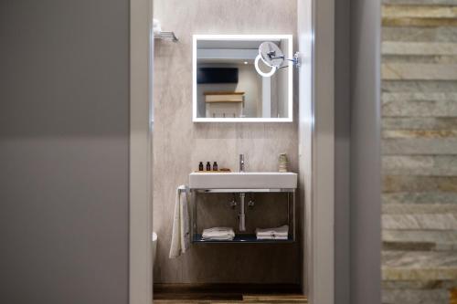 a bathroom with a sink and a mirror at OGGI e DOMANI in Naples