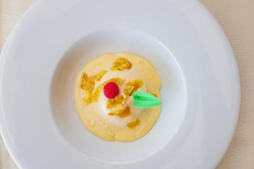 a white bowl with a dessert on a white plate at Best Western Hotel La Conchiglia in Palinuro