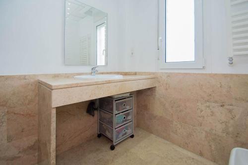 a bathroom with a sink and a mirror at Granada-otura -Villa hoyo 7-NIEVE -CAMPO DE GOLF,PLAYA CERCANA CARGADOR ELECTRICO RAPIDO in Otura