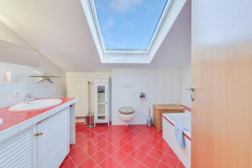 a bathroom with a sink and a skylight at Muc City de Lux 120 qm in Munich