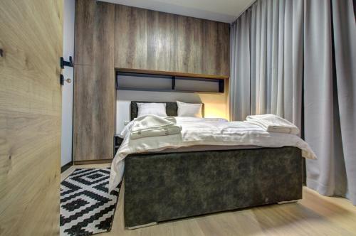 a bedroom with a large bed in a room at Apartment A17 LUX in Jahorina