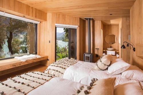 En eller flere senger på et rom på Lodge Tagua Tagua, Puelo Patagonia