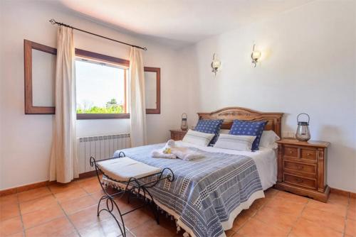 a bedroom with a bed with a cat laying on it at Villa Musset in Ibiza Town