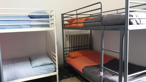 a room with three bunk beds in a room at MovidaBlablabla in Bari