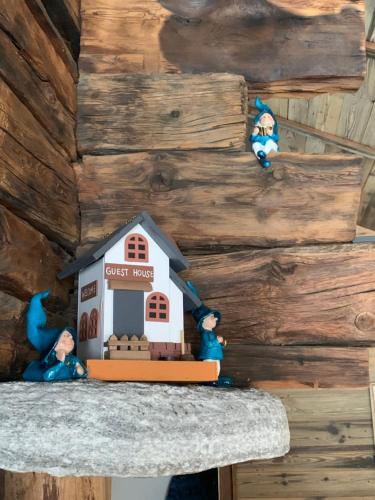 a toy house sitting on a counter with two figurines at Châlet Birkhahn in Saas-Fee