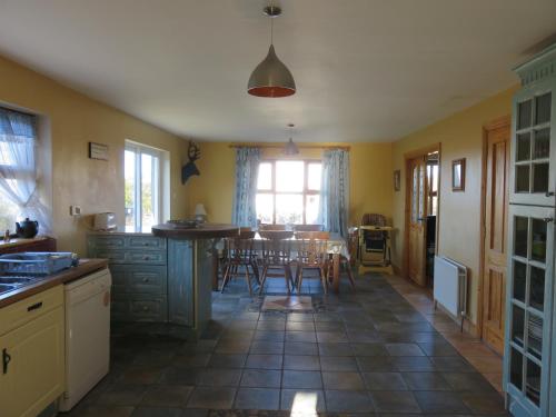 a kitchen and dining room with a table and chairs at BunkHouse - Letterfrack Farm in Letterfrack