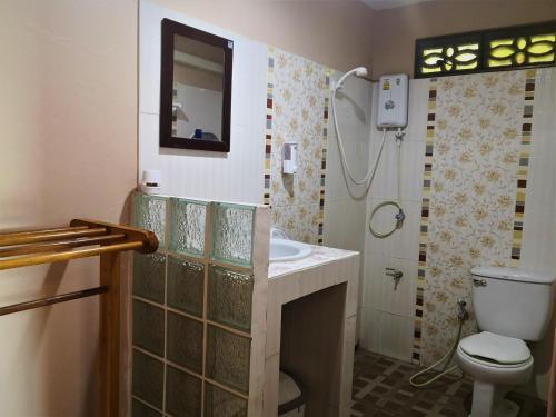 a bathroom with a toilet and a sink at Mama O Chai Koh Tao in Koh Tao