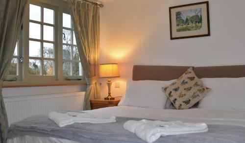 a bedroom with a bed with towels on it at Three Horseshoes Country Inn in Barry